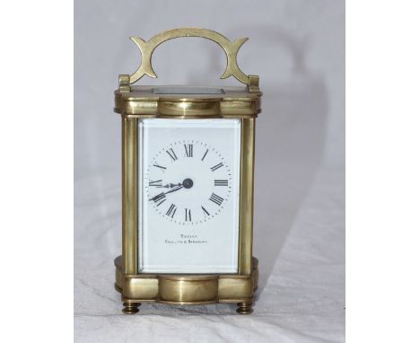 A French brass carriage clock, with exposed platform escapement and white enamel dial with Roman numerals denoting hours and 