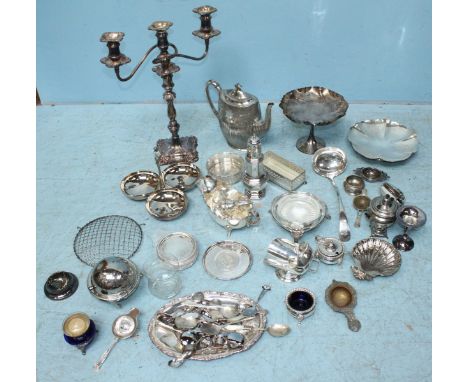 A collection of silver-plated items including a candelabra, coffee pot, various serving dishes, large ladle etc