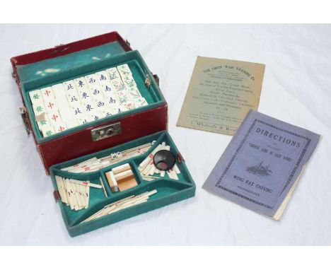 A bamboo and bone mahjong set with lacquered tile stands with hinged covers