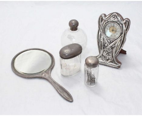 A silver-mounted Art Nouveau easel clock, Chester, 1921,17cm high, together with a silver-back hand mirror and three silver-t