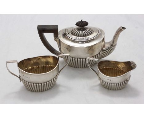 A Victorian silver tea set comprising teapot with ebonised handle and finial, cream jug and sugar bowl with half-reeded body,