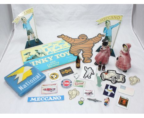 Various Michelin Man badges, Meccano and Michelin enamel badges and cardboard signs, together with a National Benzole sign an