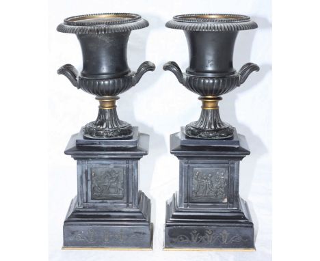 A pair of Victorian patinated bronze and slate clock-garniture classical campagna pedestal urn vases, 32cm