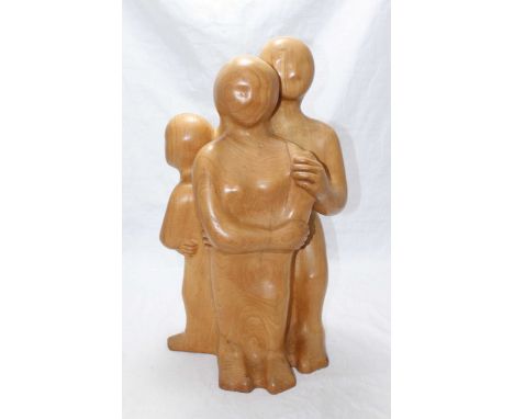 An elm carved wooden sculpture of a family group, in the style of Henry Moore, stamped to the underside of base 'R. Thompson,