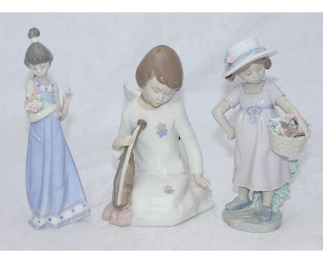 Two boxed Lladro ceramic figures of girls with baskets of flowers, together with a boxed Nadal figure of an angel.