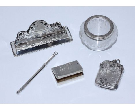 An Edwardian silver menu holder together with a silver vesta case, silver snuff box with reeded cover, silver-mounted glass m