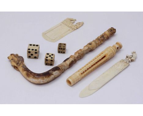 An early 20th century ivory book mark with 'Snake Charmer' finial and another with 'Blood Hound' finial, together with a carv