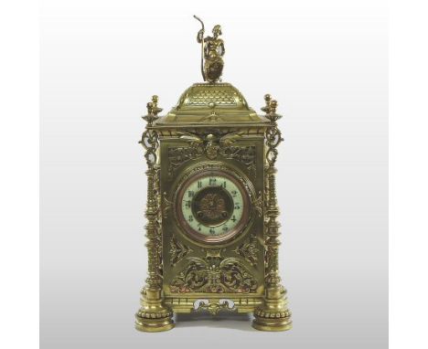 An ornate 19th century French pierced brass cased mantel clock, surmounted by a figure, the enamel chapter ring showing Arabi