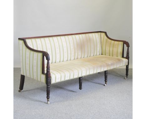 A Regency carved mahogany and green upholstered sofa, on reeded legs, 192cm