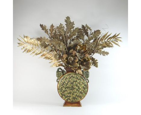 A 19th century continental majolica moon flask, the shoulders decorated with ram's heads, 35cm high, filled with gilt painted