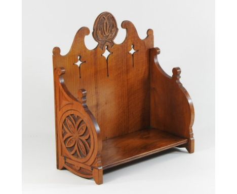 An early 20th century fruitwood book trough, with fret carved decoration, 32cm wide