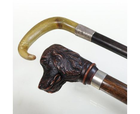 A Victorian silver mounted walking stick, with a horn handle, together with another, with a handle in the form of a hounds he