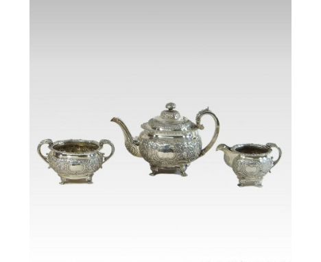 A George IV Irish three-piece silver tea service, of circular shape, relief decorated with flowers, on paw feet, comprising a