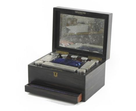 A Victorian ebony dressing case, the hinged lid inscribed MAR the fitted interior containing various silver mounted glass lid