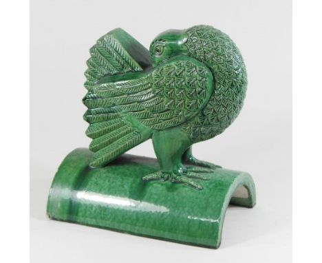 A Chinese green glazed ridge tile, in the form of a turkey, 25cm high