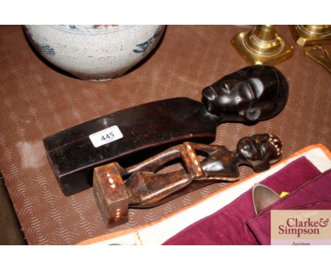 Two carved hardwood and mother of pearl inlaid ethnic figures 