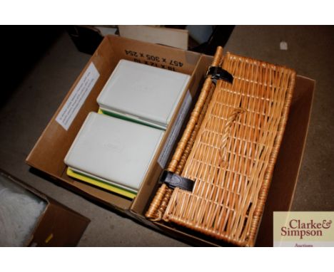A wicker picnic hamper with new plastic plates, bowls and cutlery; also two Coleman cool boxes and cool cups with lids
