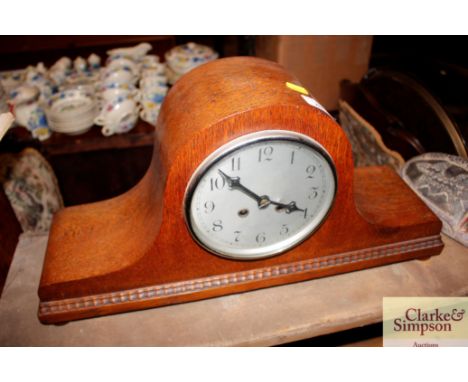 A 1920's oak striking mantel clock
