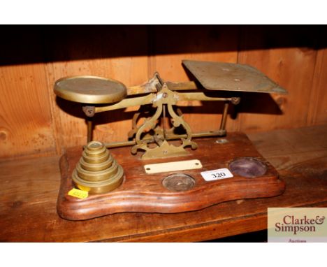 A set of wooden and brass scales with some weights 