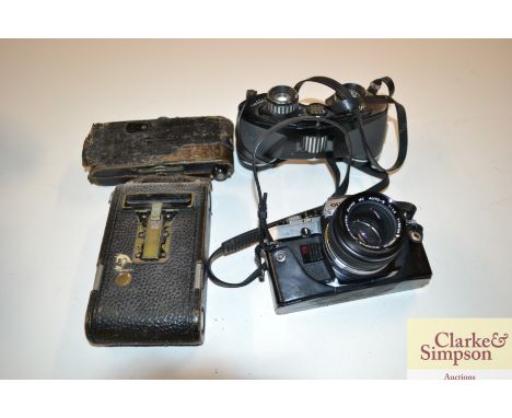 An Olympus camera; two vintage cameras and a pair of binoculars 