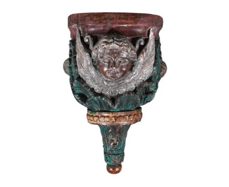 A HAND CARVED POLYCHROME PAINTED WOODEN WALL BRACKET 20TH CENTURY With the face of a cherub approximately 52cm high, 36cm wid
