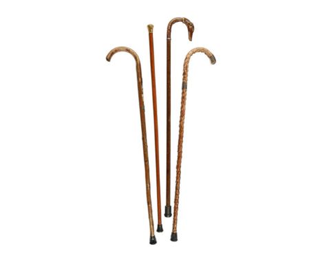 A COLLECTION OF FOUR WALKING STICKS LATE 19TH AND EARLY 20TH CENTURY Comprisng an 18ct gold topped example with monogram to t