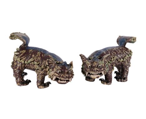 A PAIR OF DECORATVE CHINESE GLAZED POTTERY LIONS 20TH CENTURY Glazed in turquoise and purple approximately 45cm long x 27cm h