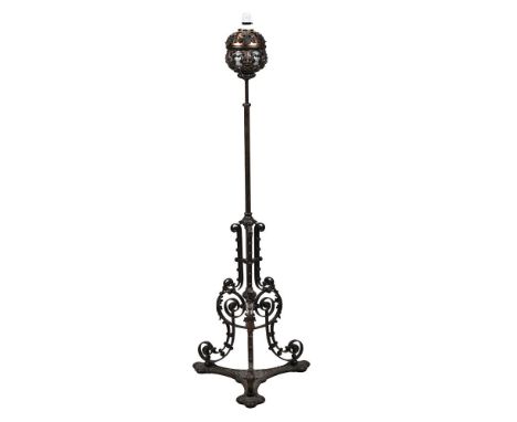 A CAST, WROUGHT IRON AND COPPER MOUNTED STANDARD LAMP  CIRCA 1900 AND LATER FITTED FOR ELECTRICITY 138cm high, 45cm wide at b