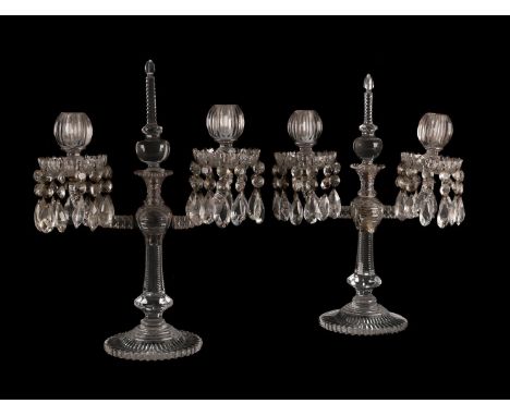 A PAIR OF TWO-LIGHT CUT GLASS TABLE LUSTRES  MID 19TH CENTURY  Each with an upright finial and flanked by the twin lustre hun