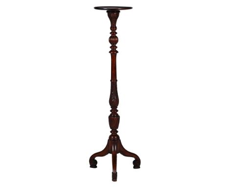 A MAHOGANY TORCHERE STAND  19TH CENTURY With carved, turned, and wrythen stem above tripod base 137cm high, the platform 31cm