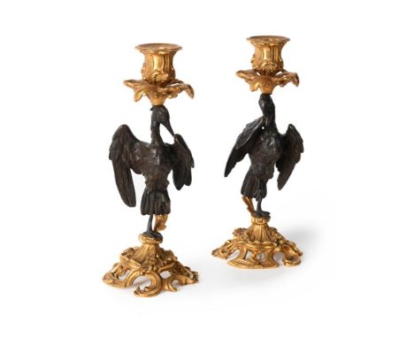 A PAIR OF FRENCH BRONZE AND ORMOLU ANIMALIER CANDLESTICKS  LATE 19TH CENTURY  Stems in the form of storks, rococo scroll base
