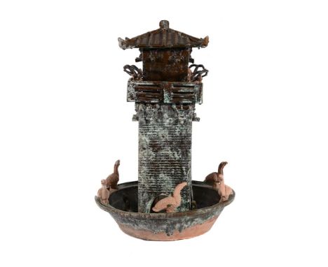 A CHINESE POTTERY MODEL OF A WATCH TOWER HAN DYNASTY OR LATER Green glazed 57cm high  Provenance: Private Collection  Conditi