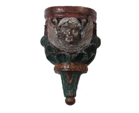A HAND CARVED POLYCHROME PAINTED WOODEN WALL BRACKET 20TH CENTURY  With the face of a cherub approximately 52cm high, 36cm wi
