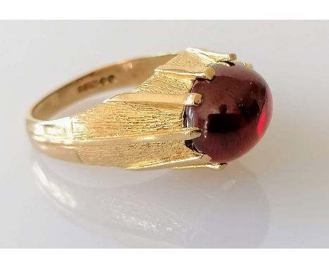 A mid-century 9ct gold gypsy ring with garnet cabochon, size R, hallmarked, 6.07g