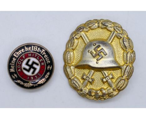 A World War Two (WW2 / WWII) style German Wound Badge and an enamel lapel badge.