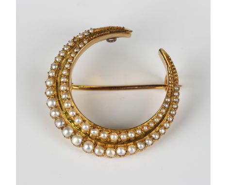 A gold and seed pearl brooch, circa 1900, designed as a crescent, mounted with two rows of graduated seed pearls, unmarked, w