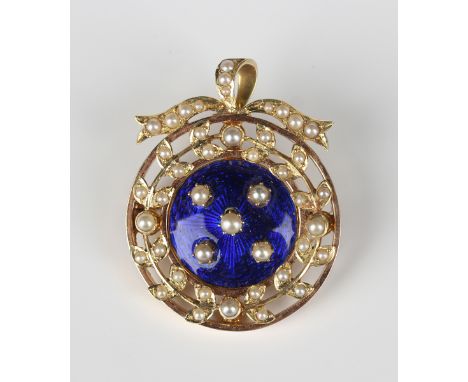 A gold, blue enamelled and seed pearl circular pendant brooch, circa 1910, mounted with five seed pearls to the centre agains