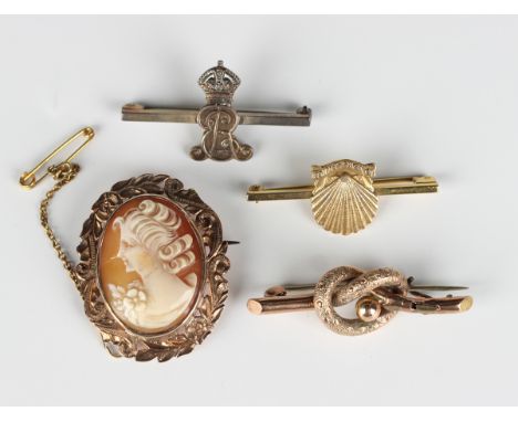 A gold mounted oval shell cameo brooch, carved as a portrait of a lady with flowers, detailed '9ct', width 2.9cm, a 9ct gold 