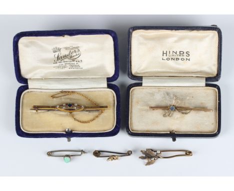 A gold, seed pearl and dark blue paste bar brooch, detailed '9ct gold', fitted with a safety chain, width 6.1cm, a gold and p