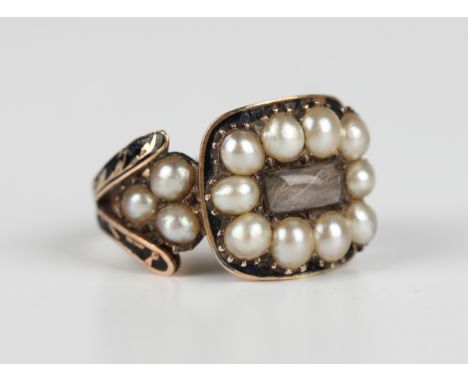 A Victorian gold, black enamelled and half-pearl mourning ring, glazed with a hair locket compartment between split shoulders