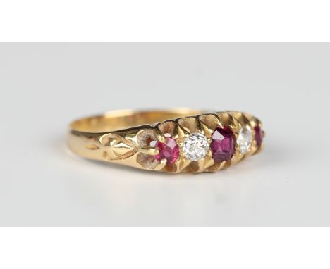 An 18ct gold ruby and diamond five stone ring, first quarter of the 20th century, mounted with three cushion cut rubies alter