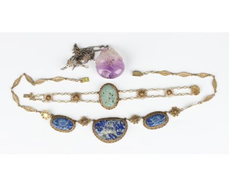 A Chinese carved amethyst pendant, designed as a peach with a foliate surmount, length 3.6cm, with a neckchain, length 61.5cm