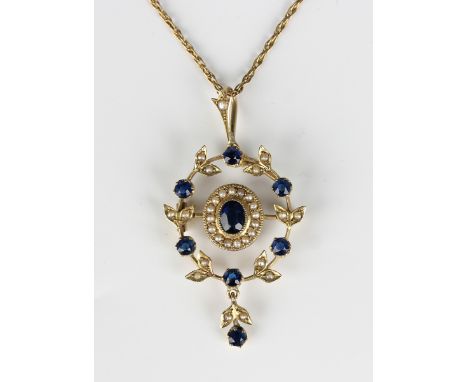 A gold, seed pearl and blue paste set pendant, circa 1910, in an oval cluster and wreath design, the front with a pendant dro