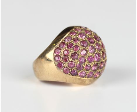 A gold and ruby ring in a bombé design, mounted with circular cut rubies, detailed '14K', weight 6.4g, ring size approx I. Pr