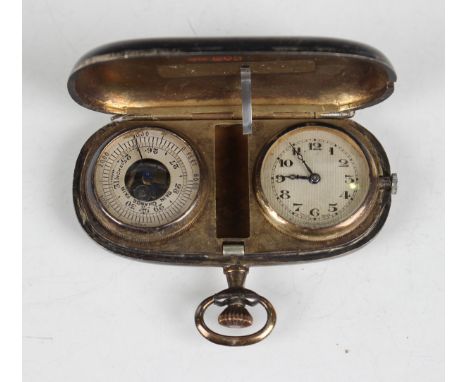 A George V silver pocket barometer and watch case of oval form, the hinged front revealing a brass cased circular barometer a