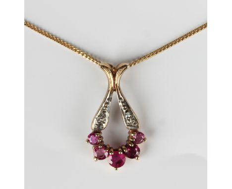 A 9ct gold, ruby and diamond drop shaped pendant, claw set with five graduated circular cut rubies and two pairs of circular 