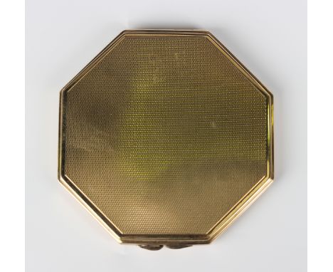A 9ct gold octagonal powder compact, the exterior with engine turned decoration, fitted with a mirror, London 1935, weight in