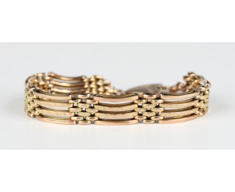 A gold curved bar and decorated bar link gate bracelet, circa 1910, on a gold heart shaped padlock clasp with engraved decora