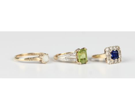 A 9ct gold ring, claw set with a cut cornered rectangular step cut peridot between diamond set shoulders, ring size approx K1