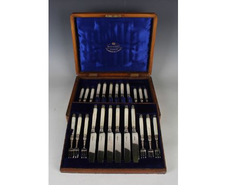 A set of twelve late Victorian silver and mother-of-pearl handled dessert knives and forks, Sheffield 1890 by Goldsmiths &amp